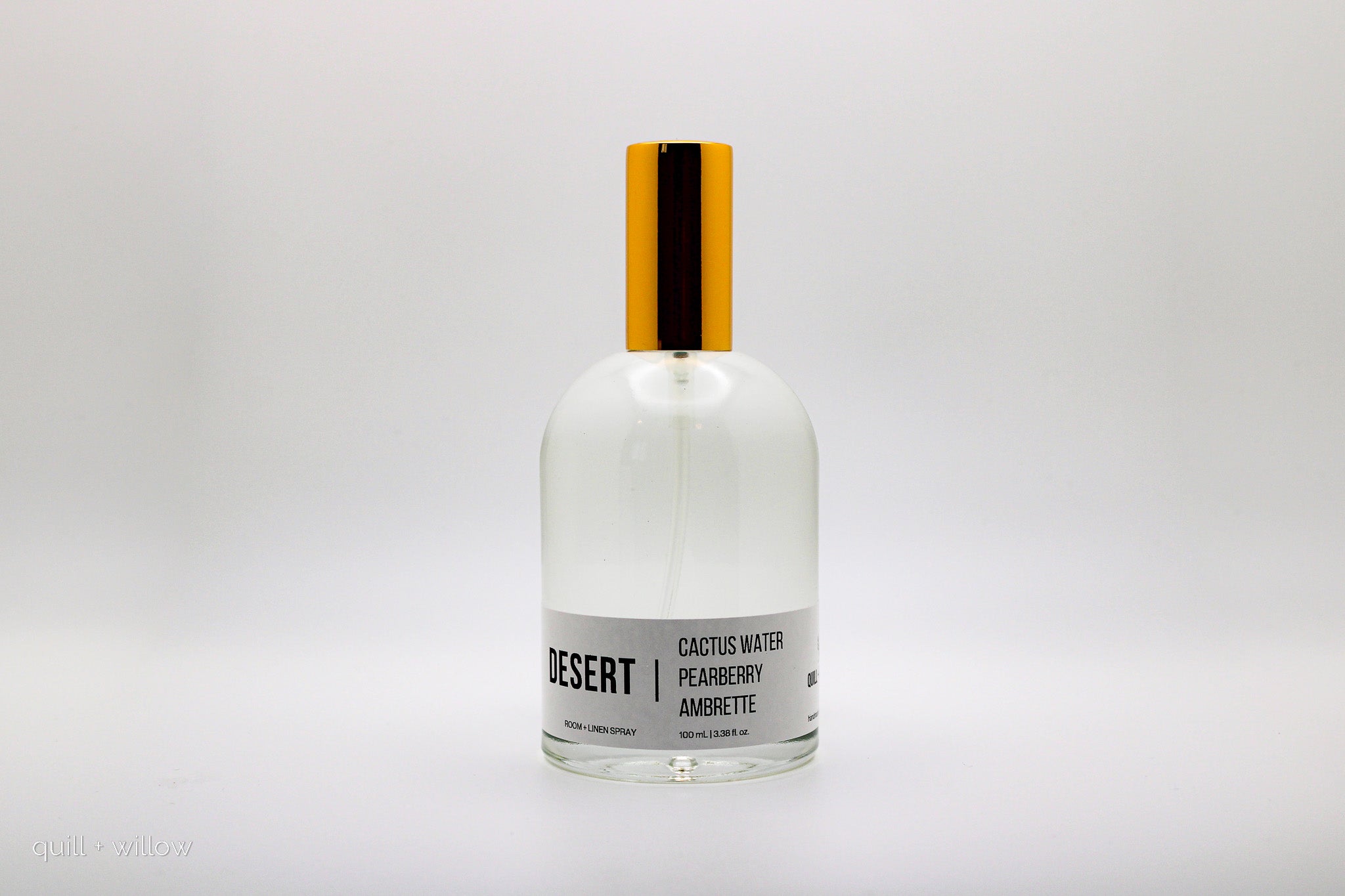 Clear bottle with gold cap on a white background