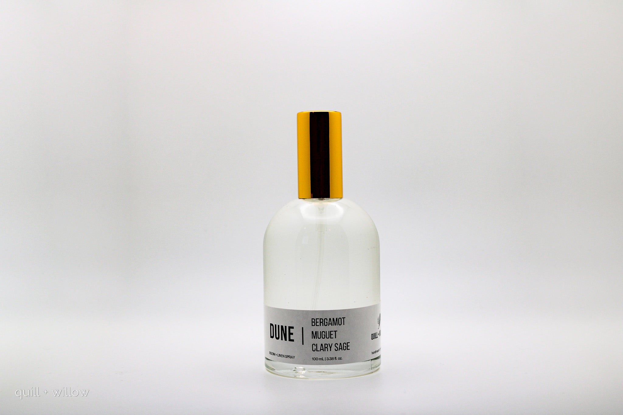Bottle of Dune room spray with a white label on a light background