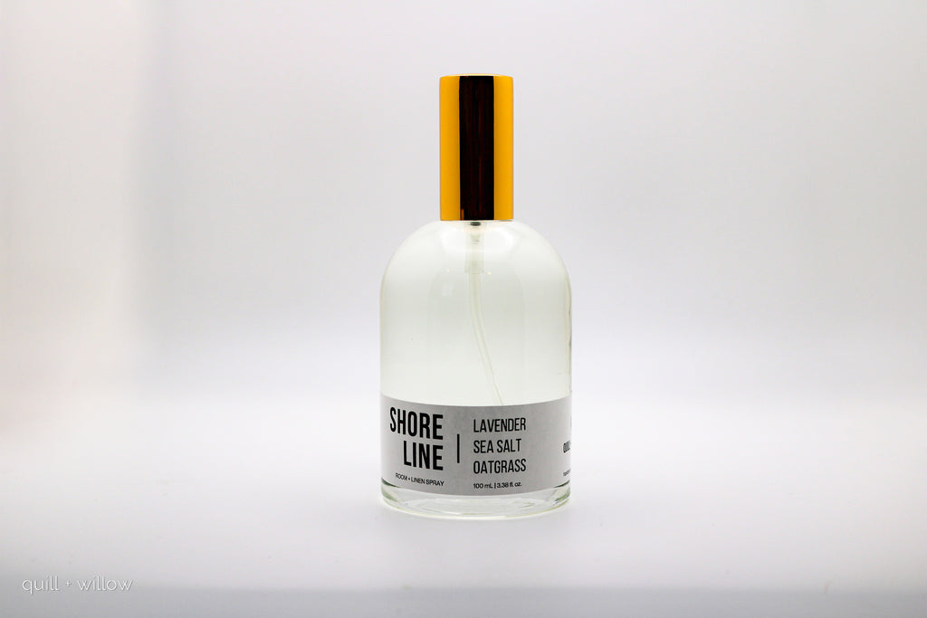 Bottle of 'Shore Line' room spray scented with lavender sea salt and oatgrass on a white background