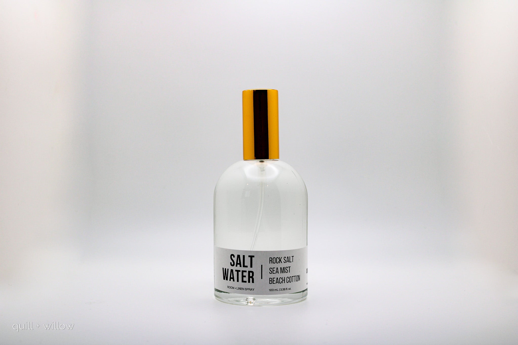 Clear bottle with a gold cap labeled 'Salt Water' on a white background