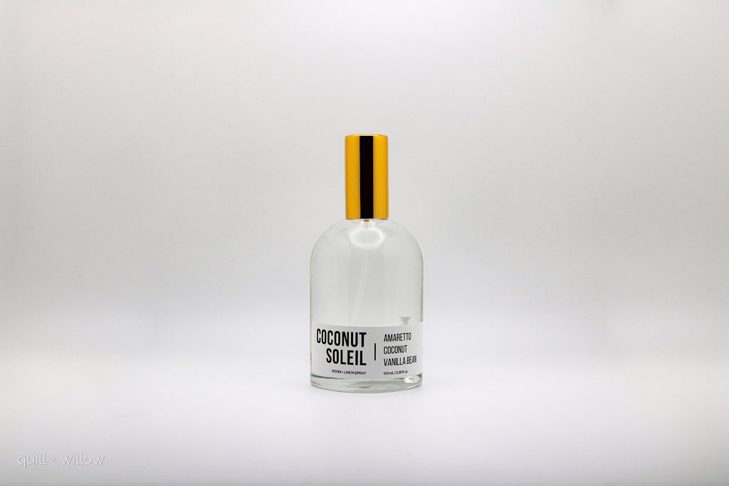 Bottle of Coconut Soleil room spray on a white background