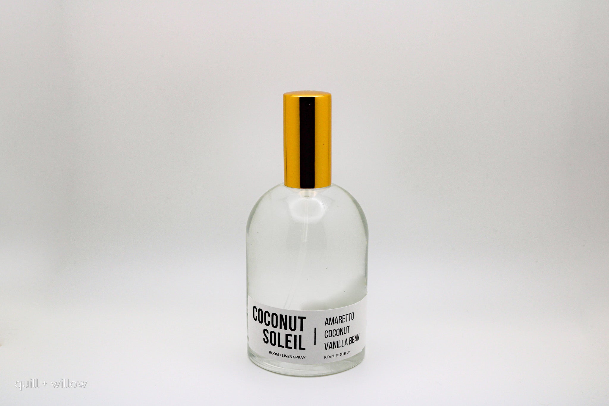 Clear bottle with gold cap labeled 'Coconut Soleil' on a white background