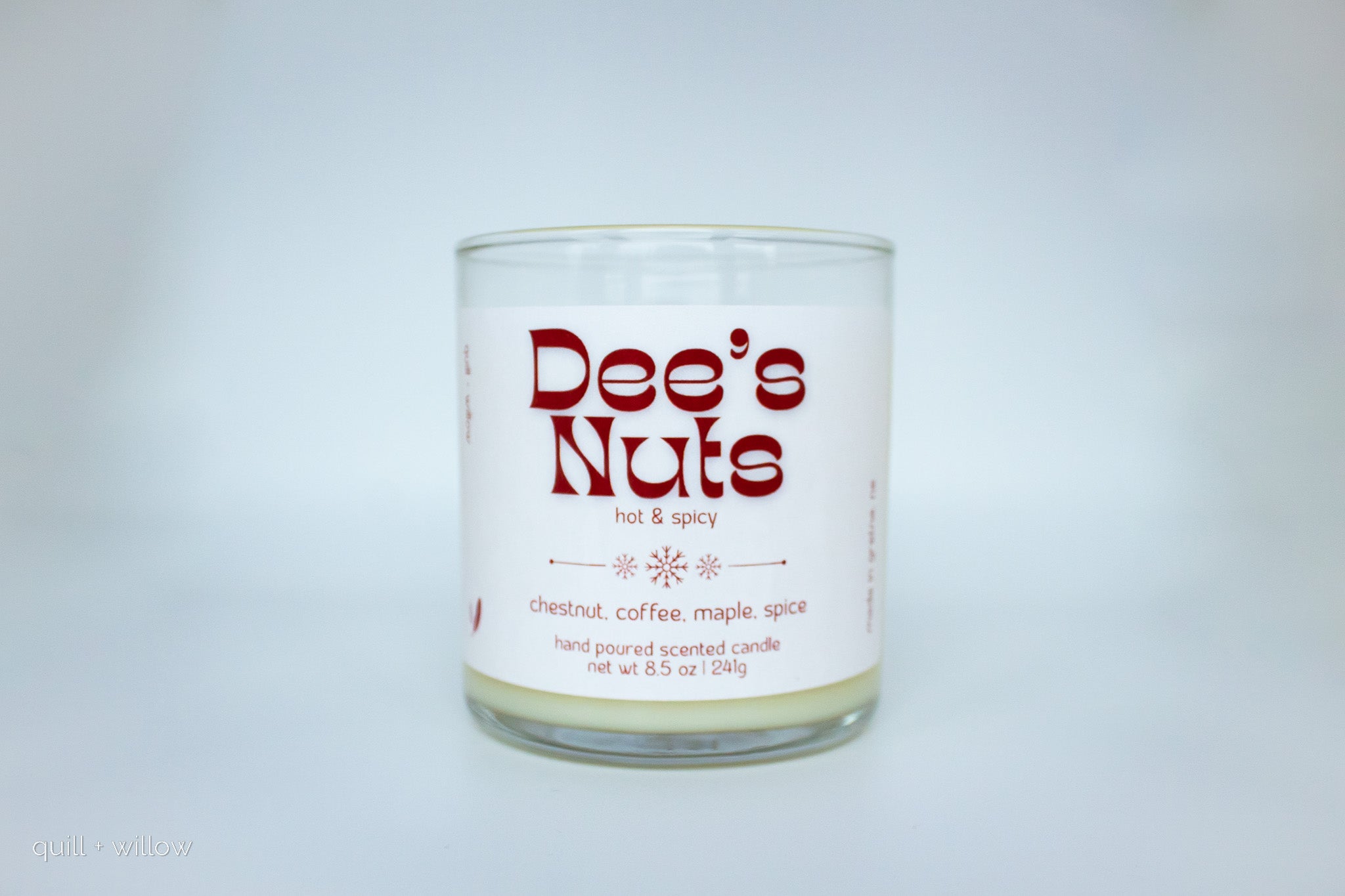 Candle with 'Dee's Nuts' label on a white background