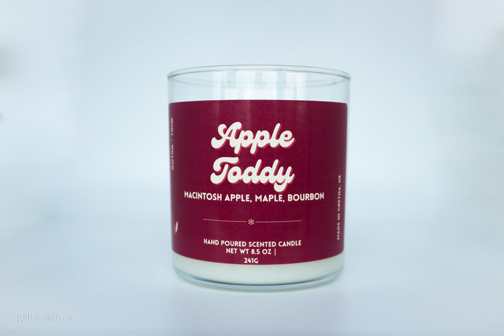 Candle with a red label on a light gray background