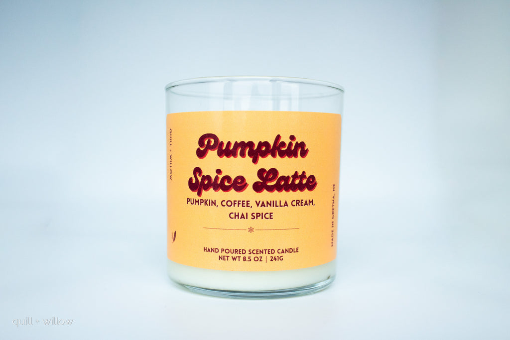Candle with a pumpkin spice latte label on a light gray background