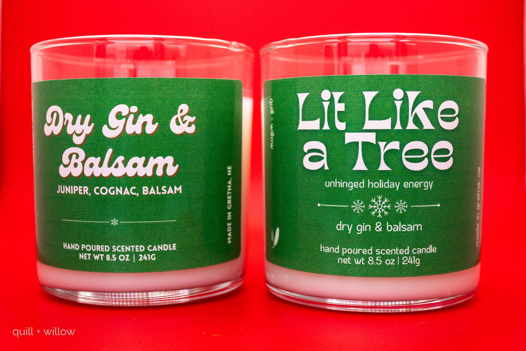 Two green candles with labels on a red background