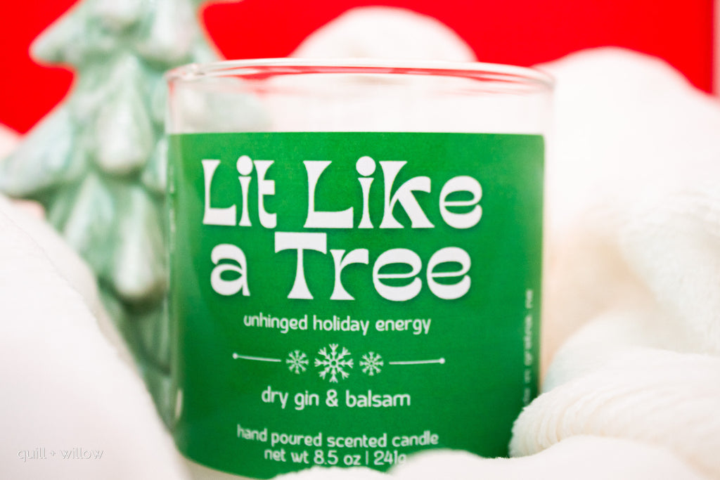 Candle labeled 'Lit Like a Tree' with festive background