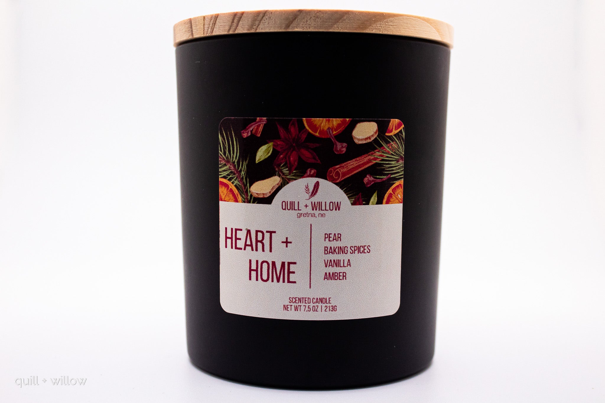 Black candle with a wooden lid and 'Heart + Home' label on a white background