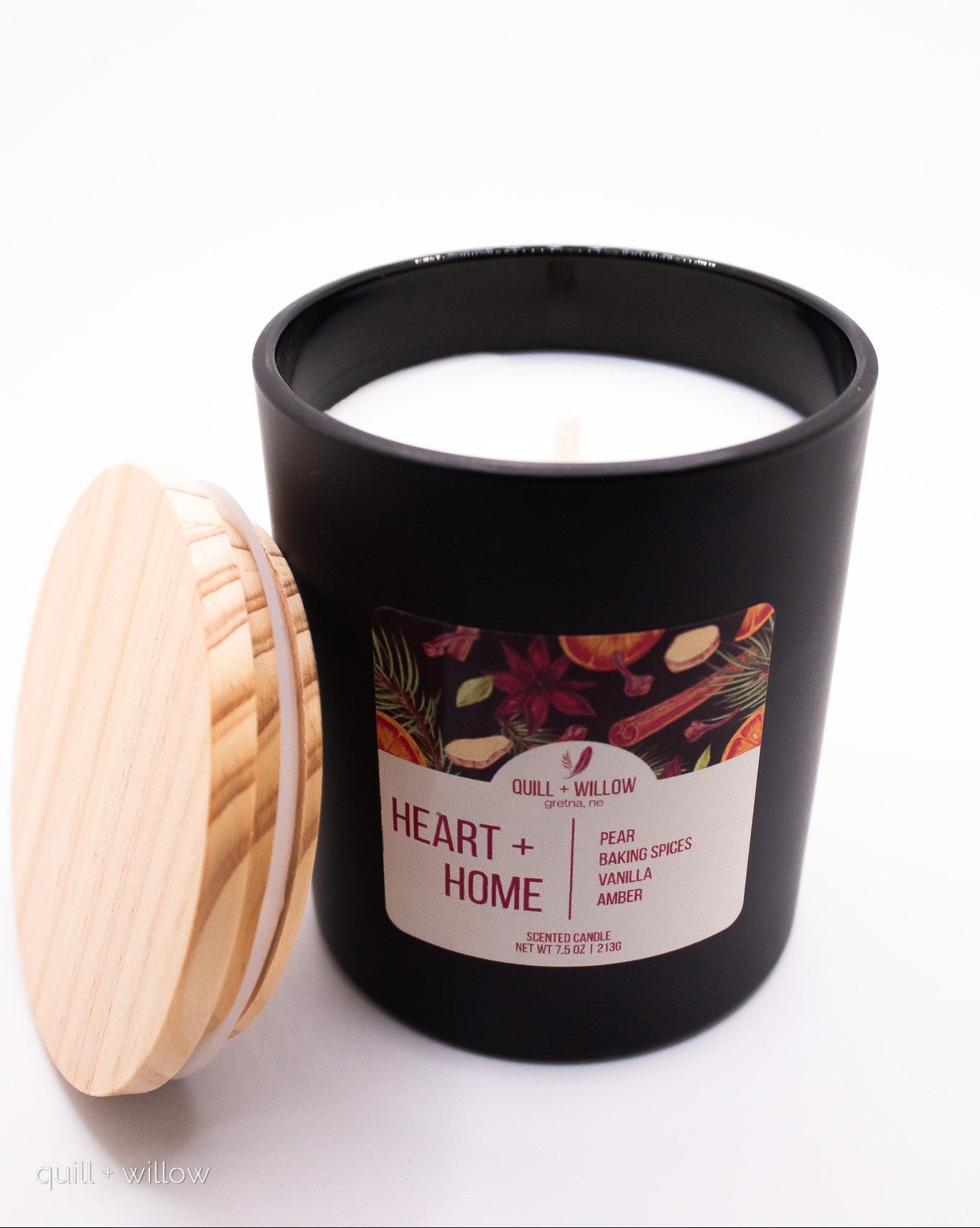 Candle with a wooden lid and 'Heart + Home' label on a white background