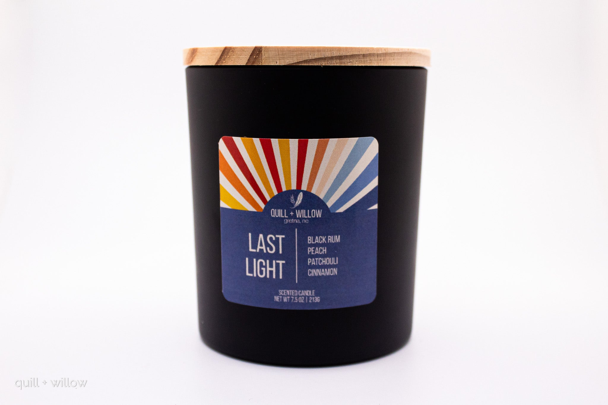 Black candle with a colorful label on a white background