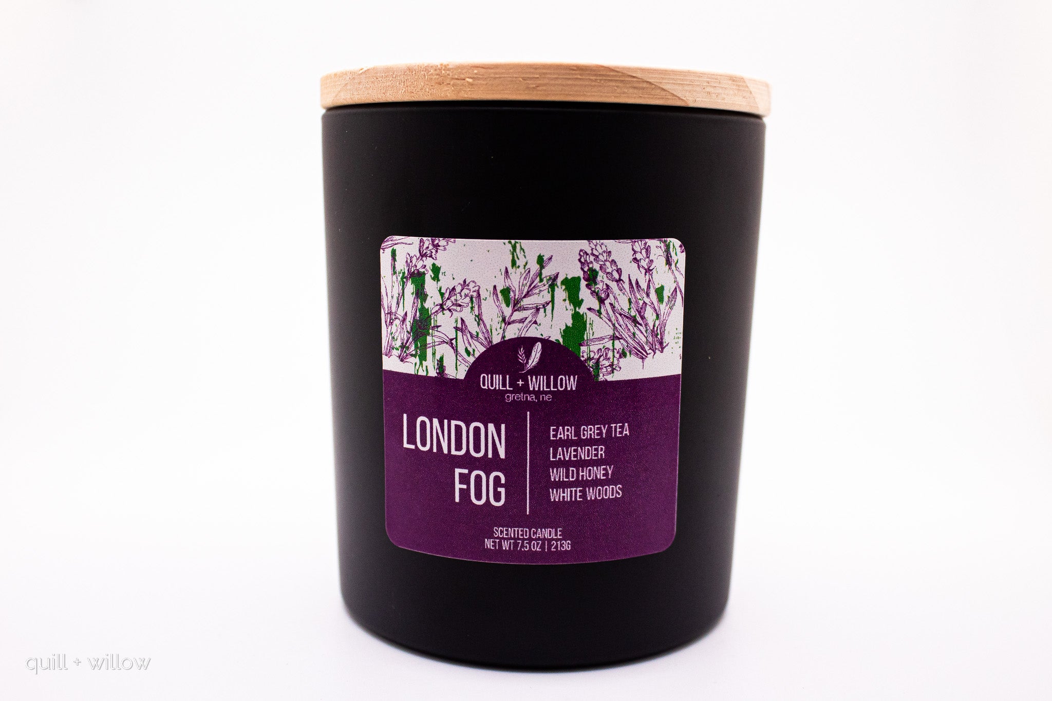 Black candle with a purple label on a white background