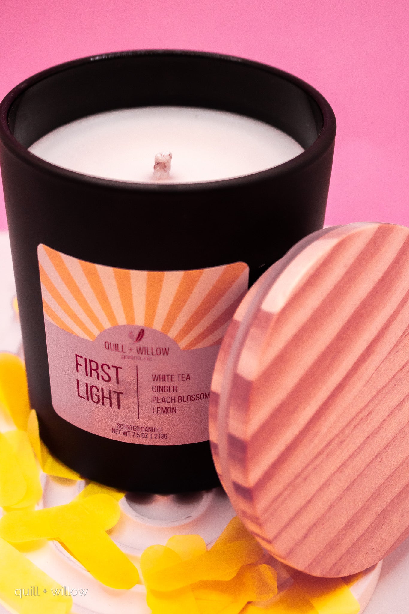 Candle with a label on a pink background