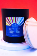 Candle with a colorful label on a red background