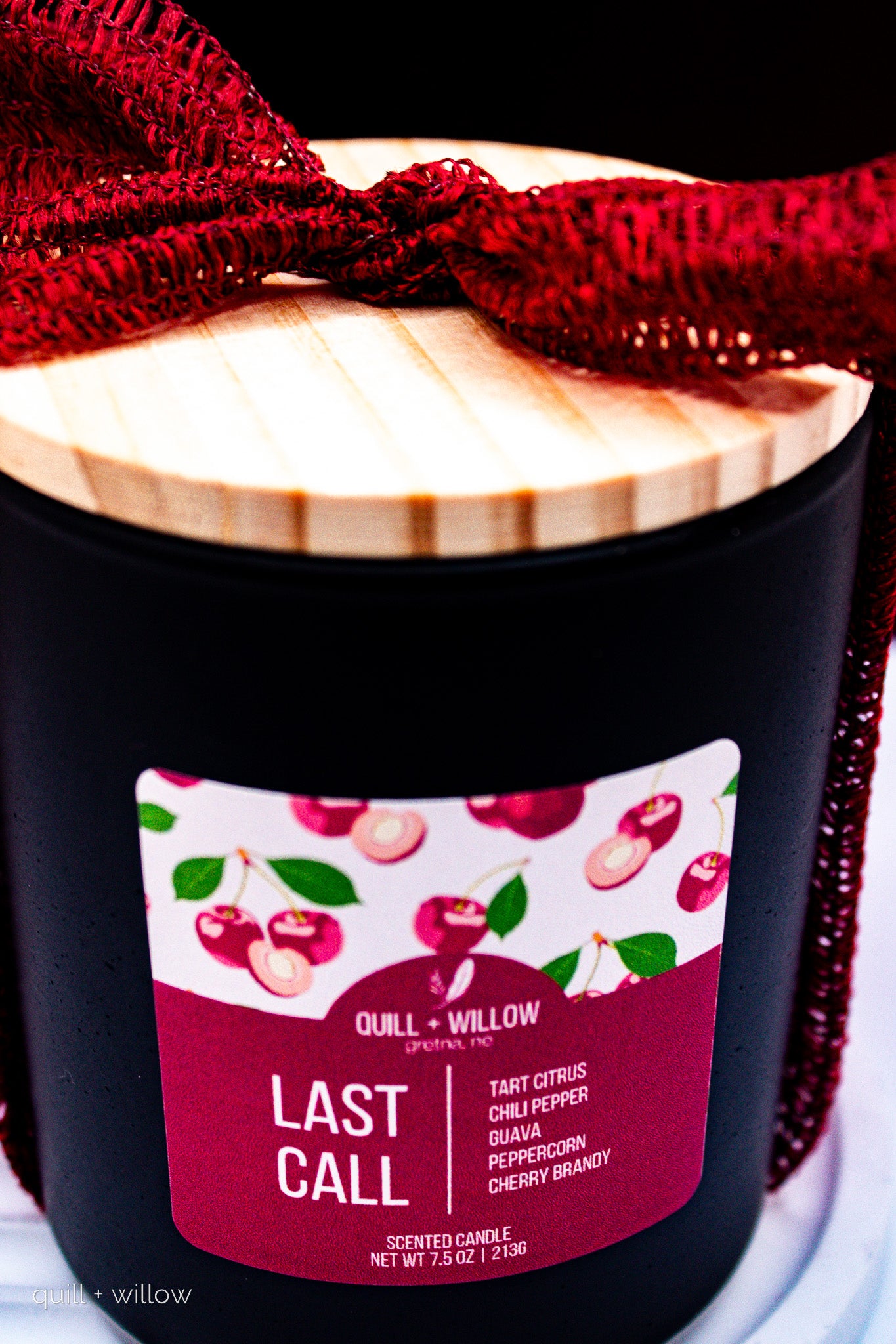 Black candle with a red ribbon and 'Last Call' label on a white background