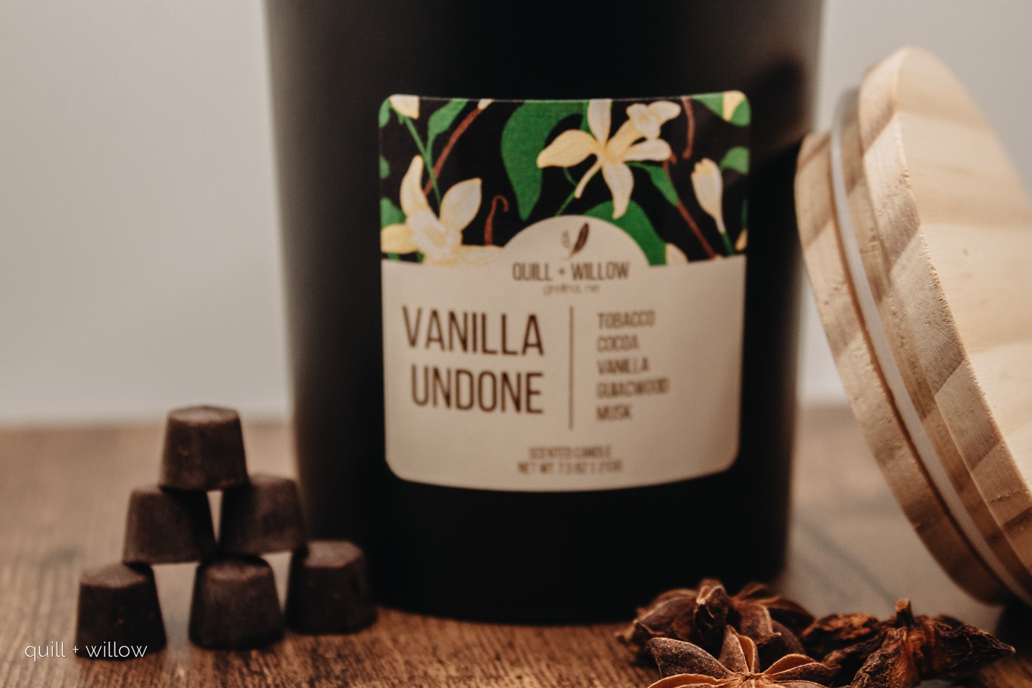 Vanilla Undone candle with decorative packaging and star anise on a wooden surface