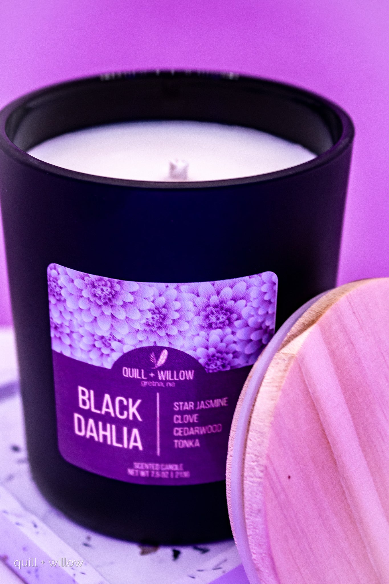 Candle with a purple label on a purple background