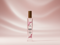 A bottle of Berry Velvet Body Mist with a gold cap and pink label, centered against a soft pink satin-textured background.