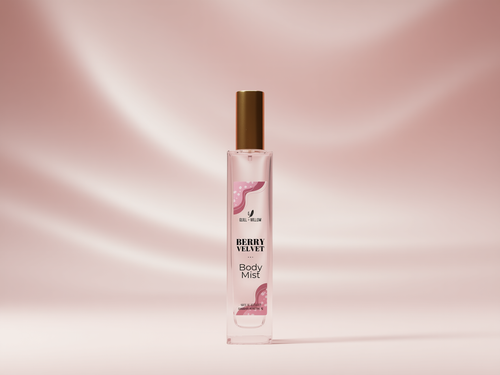A bottle of Berry Velvet Body Mist with a gold cap and pink label, centered against a soft pink satin-textured background.